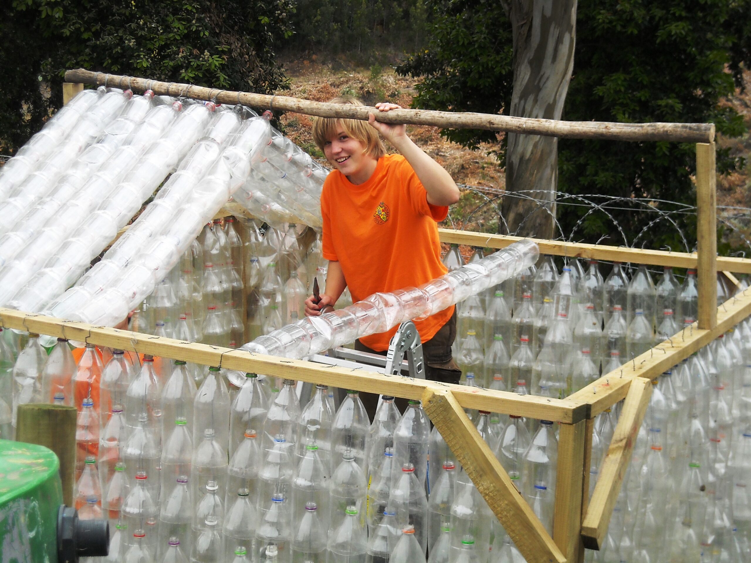Community Greenhouse built with pop bottles by volunteer Marion